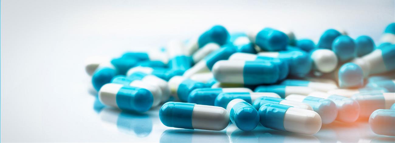 blue and white capsules pill on white background